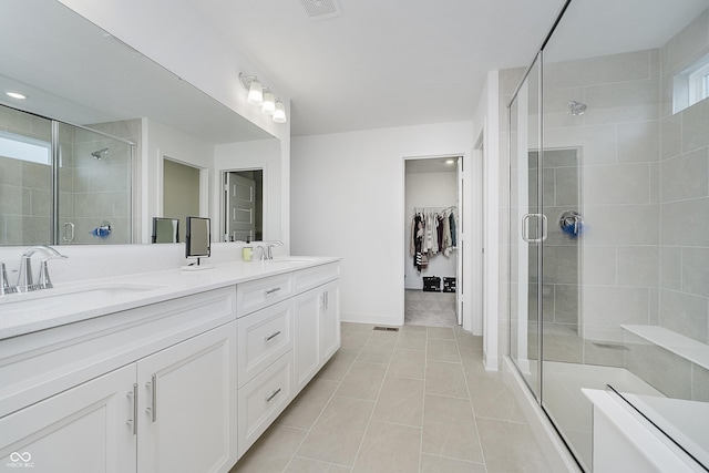 1510 Stonehaven Dr, Westfield, IN 46074 - full bathroom with a shower stall, double vanity, tile patterned floors, a spacious closet, and baseboards