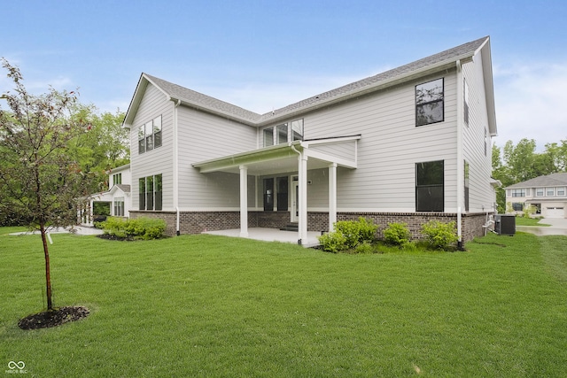 1510 Stonehaven Dr, Westfield, IN 46074 - back of house featuring central AC, a lawn, a patio area, and brick siding