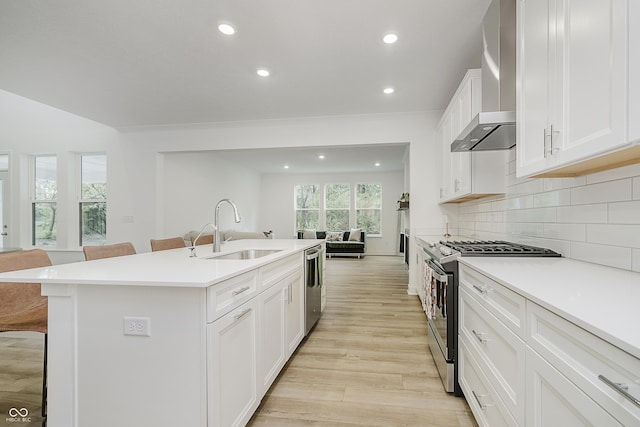 1510 Stonehaven Dr, Westfield, IN 46074 - kitchen featuring wall chimney range hood, stainless steel appliances, a sink, a kitchen breakfast bar, and recessed lighting