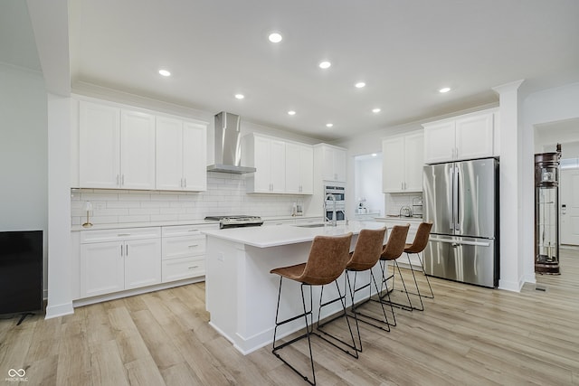 1510 Stonehaven Dr, Westfield, IN 46074 - kitchen featuring stainless steel appliances, wall chimney range hood, light wood-type flooring, backsplash, and recessed lighting