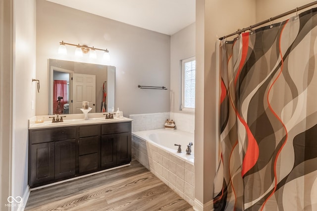 121 George Ct, Danville, IN 46122 - bathroom with a garden tub, wood finished floors, double vanity, and a shower with curtain