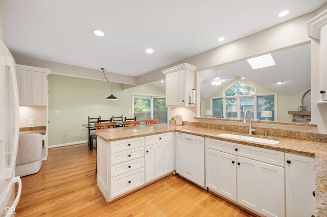 6020 Gladden Dr, Indianapolis, IN 46220 - kitchen with white appliances, a sink, a skylight, light wood-type flooring, and white cabinets