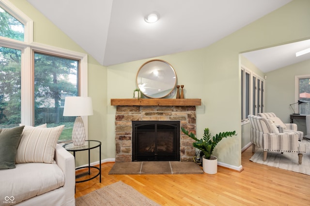 6020 Gladden Dr, Indianapolis, IN 46220 - living room featuring lofted ceiling, a stone fireplace, wood finished floors, and baseboards