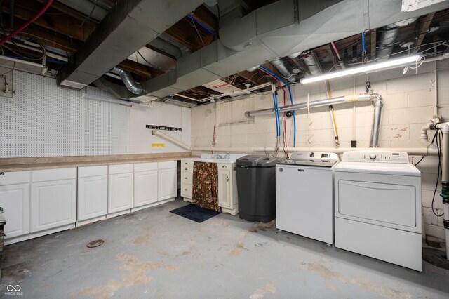 6020 Gladden Dr, Indianapolis, IN 46220 - laundry area featuring washer and dryer, cabinet space, and concrete block wall