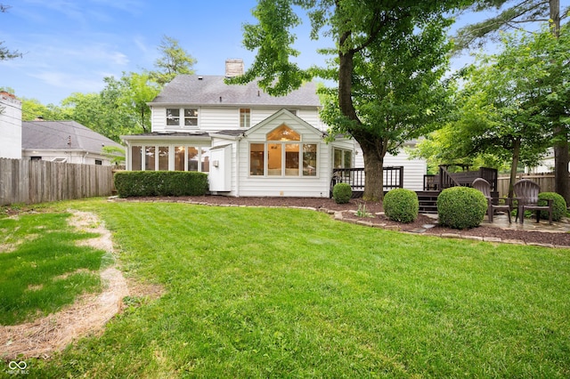 6020 Gladden Dr, Indianapolis, IN 46220 - rear view of house with a deck, a chimney, and a sunroom