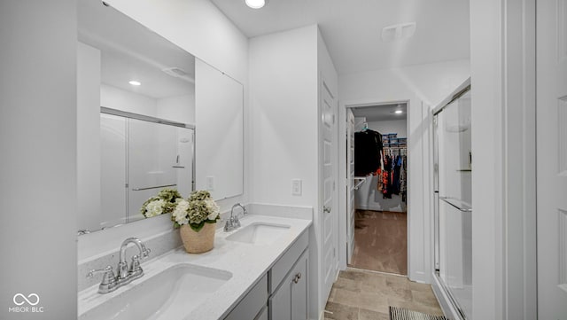 7226 Sayers Rd, Indianapolis, IN 46259 - full bathroom featuring a shower stall, a spacious closet, double vanity, and recessed lighting