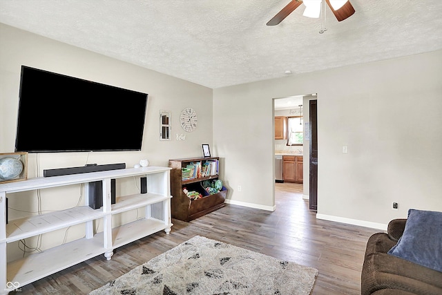 200 Forum Dr, Whiteland, IN 46184 - living room with wood finished floors, ceiling fan, baseboards, and a textured ceiling