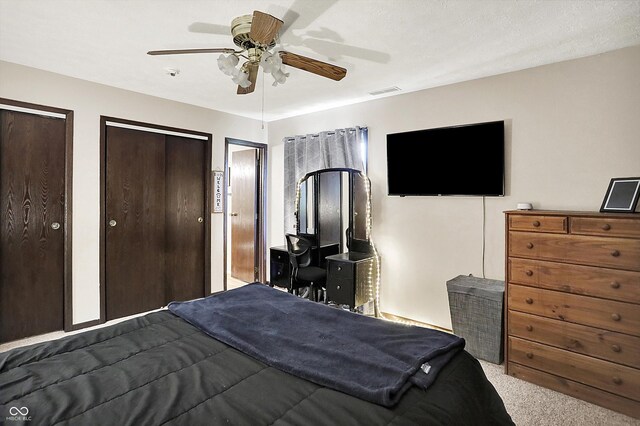 200 Forum Dr, Whiteland, IN 46184 - bedroom with dark carpet, multiple closets, and a ceiling fan