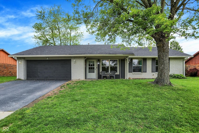 200 Forum Dr, Whiteland, IN 46184 - ranch-style home with brick siding, asphalt driveway, a garage, a front yard, and roof with shingles