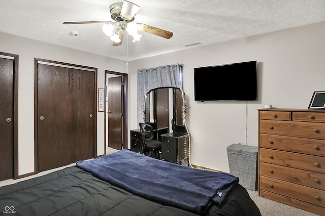 200 Forum Dr, Whiteland, IN 46184 - bedroom featuring two closets, carpet flooring, a ceiling fan, and a textured ceiling
