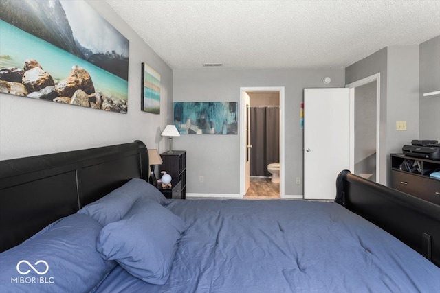 8446 S Paddleboat Ln, Pendleton, IN 46064 - carpeted bedroom featuring a textured ceiling, baseboards, and connected bathroom