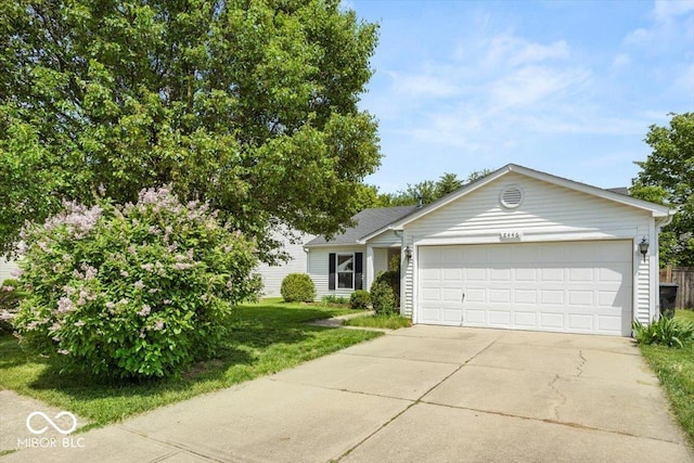 8446 S Paddleboat Ln, Pendleton, IN 46064 - view of front facade featuring a garage, concrete driveway, and a front lawn