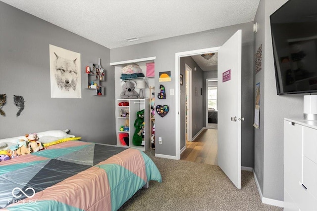 8446 S Paddleboat Ln, Pendleton, IN 46064 - bedroom with a textured ceiling, carpet floors, a closet, and baseboards