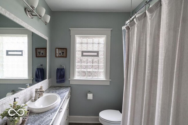 3934 N Kenwood Ave, Indianapolis, IN 46208 - bathroom featuring vanity, toilet, and healthy amount of natural light