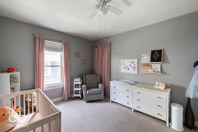 3934 N Kenwood Ave, Indianapolis, IN 46208 - bedroom featuring a crib, light carpet, baseboards, and a ceiling fan
