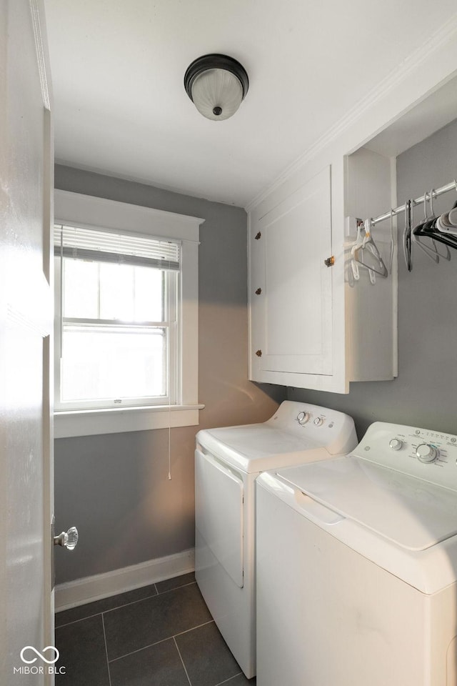 3934 N Kenwood Ave, Indianapolis, IN 46208 - washroom with washer and clothes dryer, dark tile patterned floors, and cabinet space