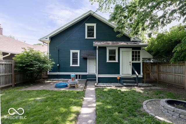 3934 N Kenwood Ave, Indianapolis, IN 46208 - rear view of house featuring entry steps, a fire pit, and a patio area