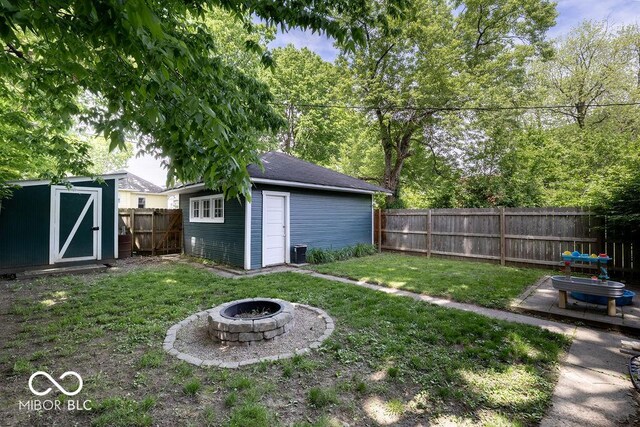 3934 N Kenwood Ave, Indianapolis, IN 46208 - view of yard featuring a fire pit and an outdoor structure