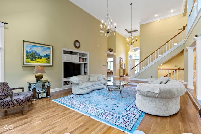 8723 Bergeson Dr, Indianapolis, IN 46278 - living area featuring a towering ceiling, wood finished floors, stairs, crown molding, and baseboards