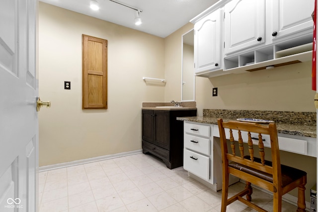 8723 Bergeson Dr, Indianapolis, IN 46278 - bathroom featuring baseboards, vanity, and track lighting