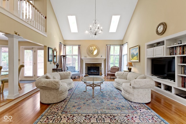8723 Bergeson Dr, Indianapolis, IN 46278 - living room with a skylight, high vaulted ceiling, wood finished floors, a chandelier, and healthy amount of natural light