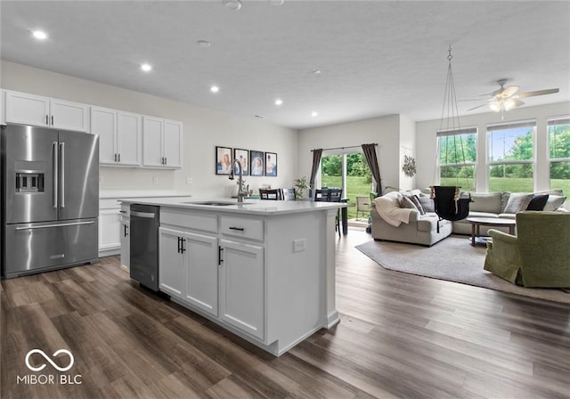 14350 Ludwell Ct, Fishers, IN 46037 - kitchen with appliances with stainless steel finishes, a sink, open floor plan, dark wood finished floors, and light countertops
