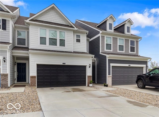 14350 Ludwell Ct, Fishers, IN 46037 - townhome / multi-family property featuring a garage, brick siding, and driveway
