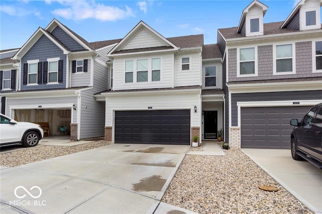 14350 Ludwell Ct, Fishers, IN 46037 - townhome / multi-family property with brick siding, a garage, concrete driveway, and roof with shingles