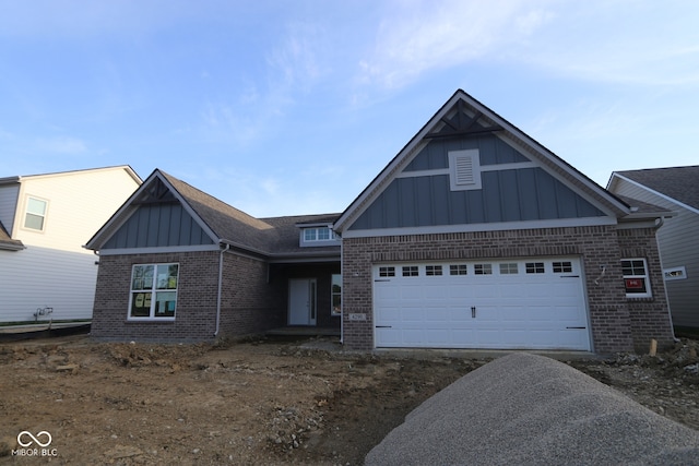 4290 Ironclad Dr, Bargersville, IN 46106 - view of front of home with board and batten siding, brick siding, driveway, and a garage