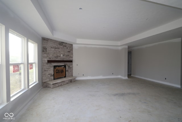 4290 Ironclad Dr, Bargersville, IN 46106 - unfurnished living room with concrete flooring, a stone fireplace, and baseboards