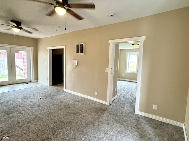 104 W Pearl St, Trafalgar, IN 46181 - spare room with ceiling fan, carpet floors, french doors, baseboards, and a textured ceiling
