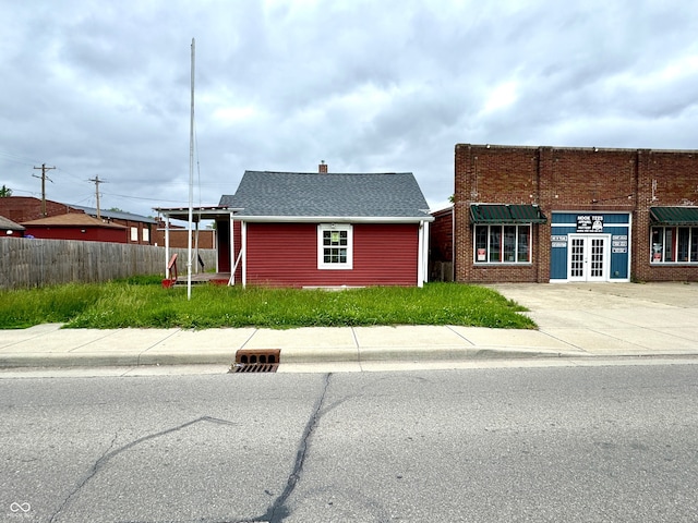 104 W Pearl St, Trafalgar, IN 46181 - view of front of house featuring a chimney, concrete driveway, and a shingled roof