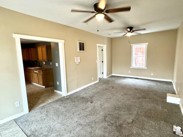 104 W Pearl St, Trafalgar, IN 46181 - spare room featuring a ceiling fan, a sink, light carpet, a textured ceiling, and baseboards