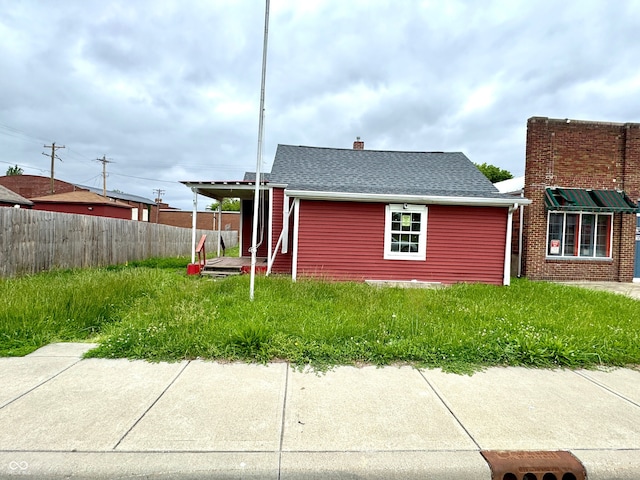 104 W Pearl St, Trafalgar, IN 46181 - view of side of home featuring roof with shingles and a chimney