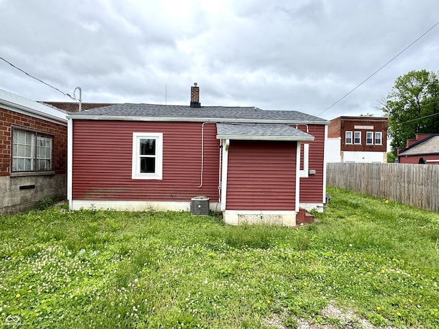 104 W Pearl St, Trafalgar, IN 46181 - view of home's exterior with a chimney, central AC, and roof with shingles