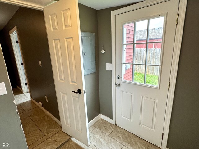 104 W Pearl St, Trafalgar, IN 46181 - doorway with electric panel, plenty of natural light, light tile patterned floors, and baseboards
