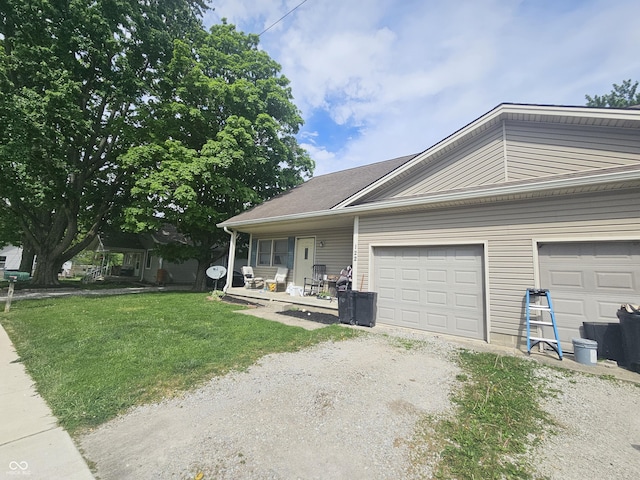 120 N Elm St, Thorntown, IN 46071 - view of front facade featuring driveway, an attached garage, a front lawn, and covered porch