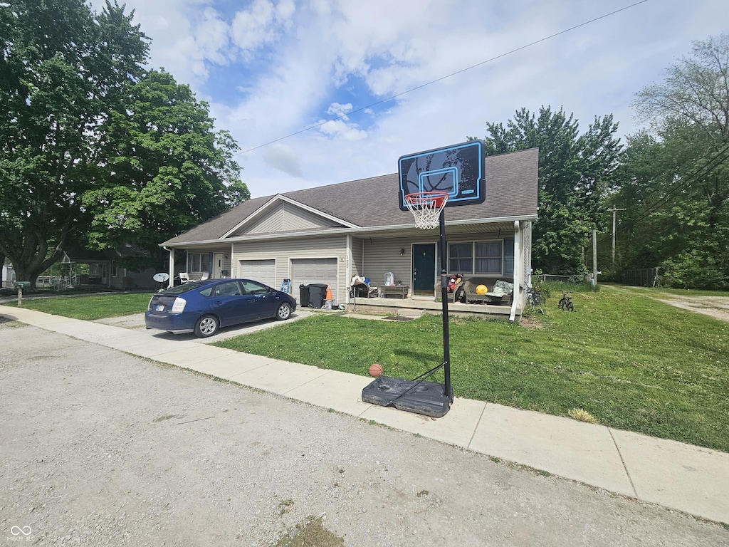 120 N Elm St, Thorntown, IN 46071 - view of front of home with a garage, a front yard, driveway, and roof with shingles