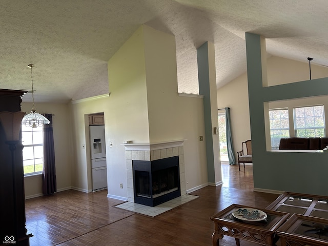 11014 Lake Run Dr, Fishers, IN 46038 - living area featuring a textured ceiling, wood finished floors, a fireplace, a chandelier, and lofted ceiling