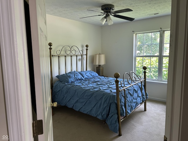 11014 Lake Run Dr, Fishers, IN 46038 - bedroom featuring carpet floors, a textured ceiling, multiple windows, a ceiling fan, and baseboards