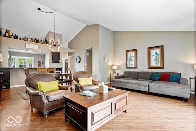 11041 Limbach Cir, Indianapolis, IN 46236 - living room with wood finished floors, a chandelier, high vaulted ceiling, and baseboards