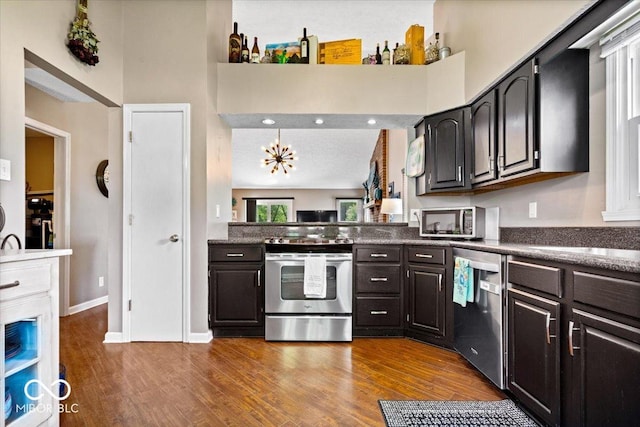 11041 Limbach Cir, Indianapolis, IN 46236 - kitchen with stainless steel appliances, dark wood-style flooring, dark countertops, and a high ceiling