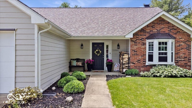 11041 Limbach Cir, Indianapolis, IN 46236 - doorway to property featuring a shingled roof, brick siding, and a yard