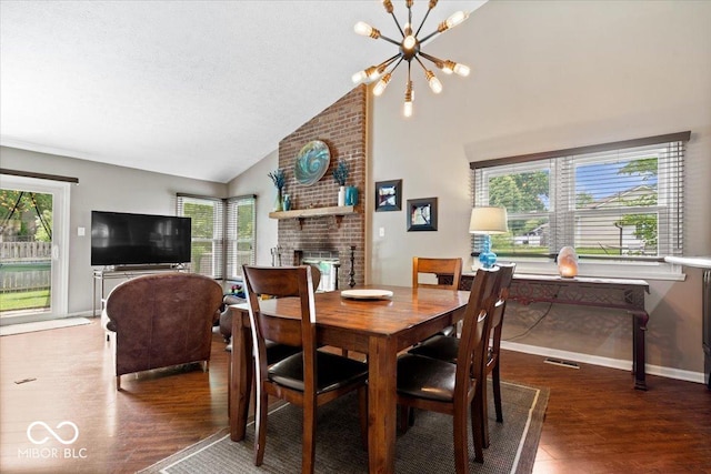 11041 Limbach Cir, Indianapolis, IN 46236 - dining area with wood finished floors, vaulted ceiling, a brick fireplace, a chandelier, and baseboards
