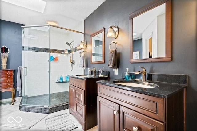 11041 Limbach Cir, Indianapolis, IN 46236 - bathroom featuring a stall shower, two vanities, a skylight, and tile patterned floors