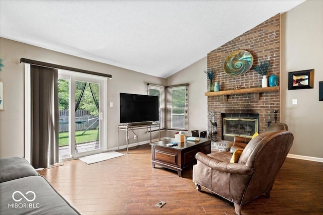11041 Limbach Cir, Indianapolis, IN 46236 - living room with wood finished floors, vaulted ceiling, baseboards, and a brick fireplace