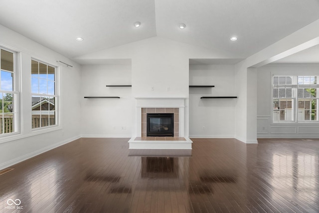 15292 Slateford Rd, Noblesville, IN 46062 - unfurnished living room with vaulted ceiling, hardwood / wood-style floors, and a tiled fireplace
