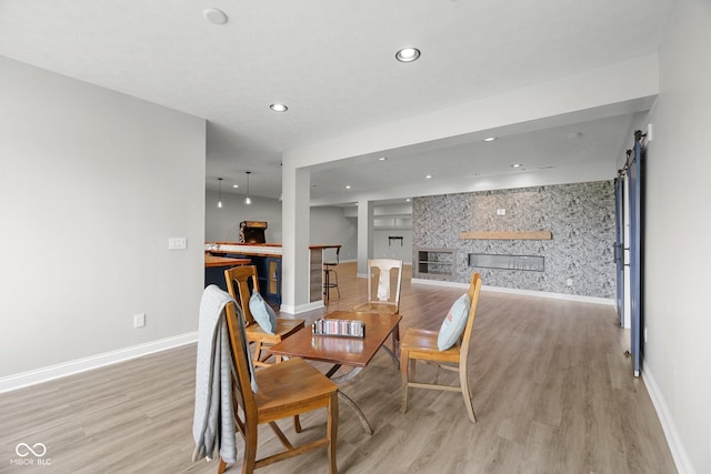 15292 Slateford Rd, Noblesville, IN 46062 - dining area with light wood-style floors, a fireplace, and recessed lighting