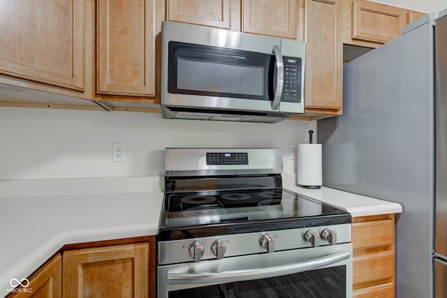 8684 Captain Dr, Avon, IN 46123 - kitchen featuring appliances with stainless steel finishes, light countertops, and light brown cabinets