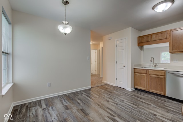 8684 Captain Dr, Avon, IN 46123 - kitchen with a sink, dishwasher, wood finished floors, decorative light fixtures, and light countertops